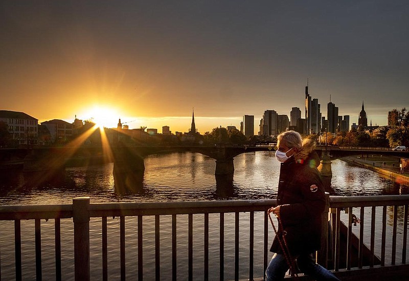 A man crosses a bridge earlier this week in Frankfurt, Germany. The European economy rebounded in the July-September quarter after a sharp downturn in the April-June period because of coronavirus lockdowns.
(AP/Michael Probst)