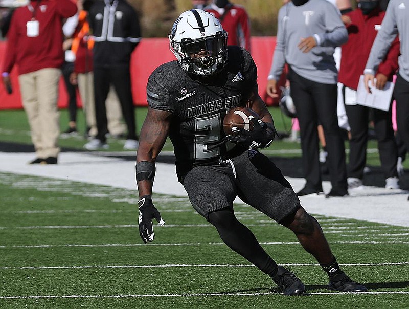 Arkansas State running back Jamal Jones (21) runs the ball during the second quarter of the Red Wolves' 38-10 loss on Saturday, Oct. 31, 2020, at Centennial Bank Stadium in Jonesboro.
(Arkansas Democrat-Gazette/Thomas Metthe)