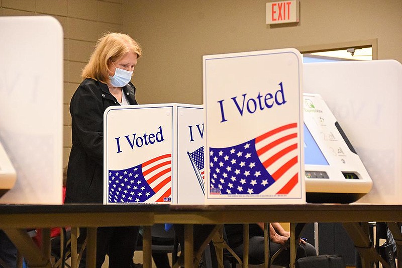 Lori Coe of Sherwood fills out her ballot Saturday, Oct. 31, 2020, at the William F. Laman Public Library in North Little Rock. (Arkansas Democrat-Gazette/Staci Vandagriff)