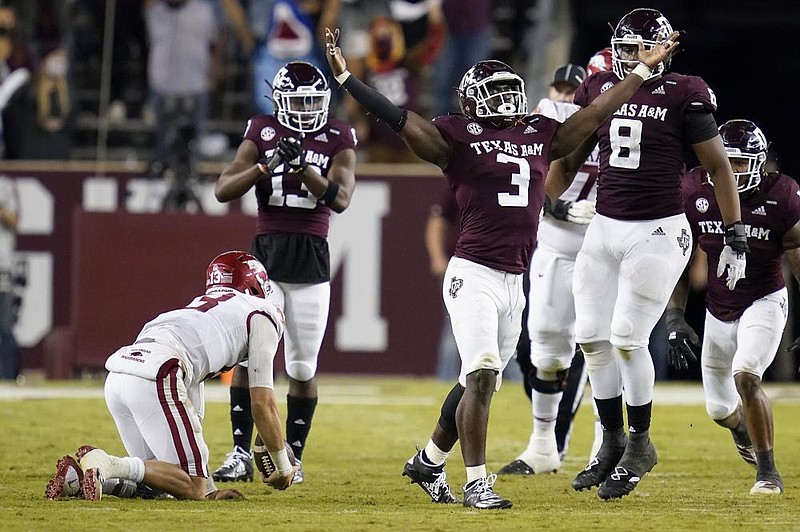 Texas A&M defensive lineman Tyree Johnson (3) reacts after sacking Arkansas quarterback Feleipe Franks (bottom left) during the second quarter Saturday in College Station, Texas. Arkansas lost 42-31 to drop to 2-3. More photos at arkansasonline.com/111razorbacks/. (AP/Sam Craft) 