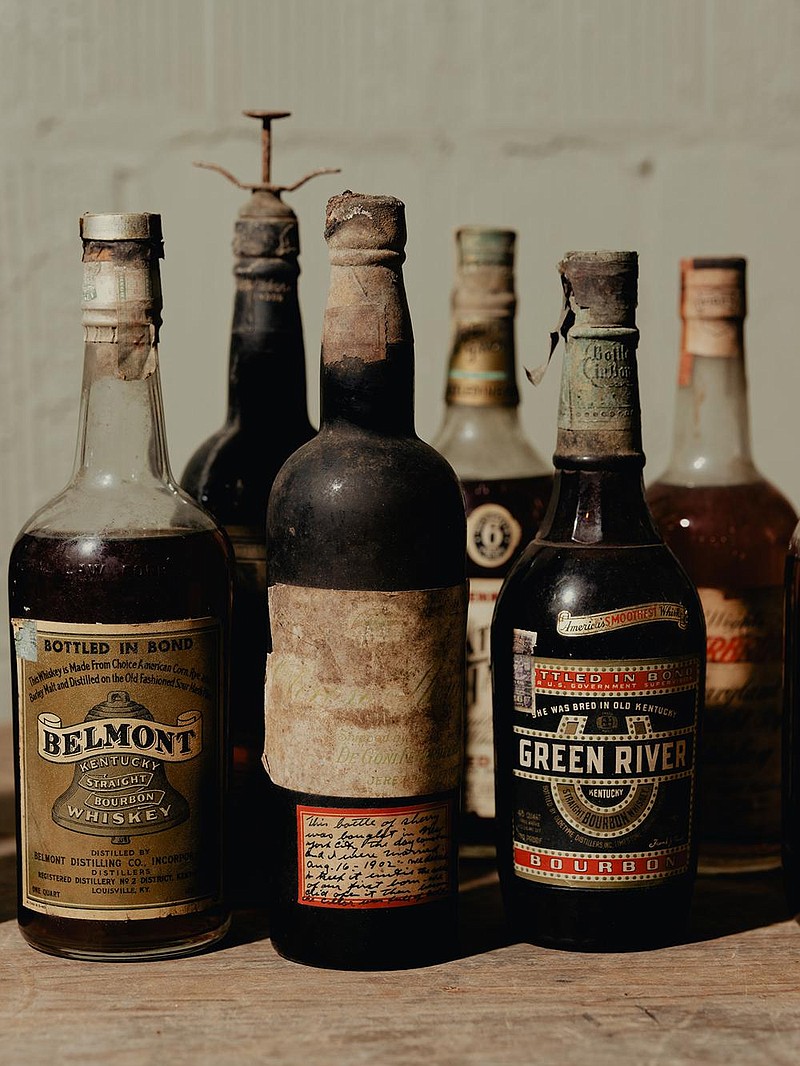 Some of Kevin Langdon Ackerman’s liquor collection, including a few prohibition-era bottles owned by American filmmaker Cecil B. DeMille, in Los Angeles, Sept. 25, 2020. Dusty hunters seek valuable old bottles of whiskey and other spirits — Ackerman found the collection of a lifetime. (Rozette Rago/The New York Times)