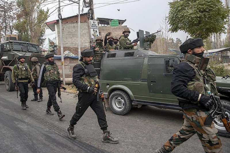 Indian army soldiers walks back towards their vehicle after a gun battle on the outskirts of Srinagar, Indian controlled Kashmir, Sunday, Nov. 1, 2020. According to police, Indian government forces killed Saifullah Mir, a top rebel commander of the region's largest rebel group, Hizbul Mujahideen which has spearheaded an armed rebellion against Indian rule for decades. (AP Photo/ Dar Yasin)