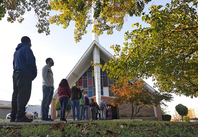 Voters line up outside Vickery Baptist Church waiting to cast their ballots on Election Day Tuesday, Nov. 3, 2020, in Dallas.