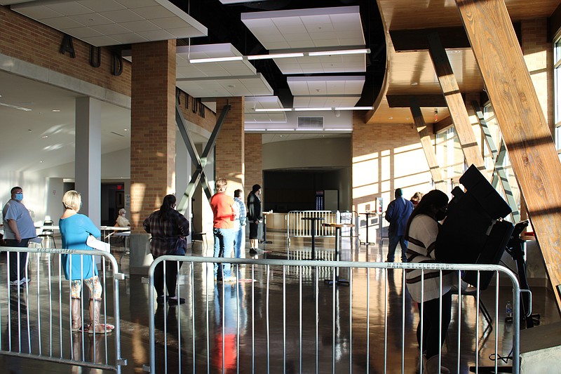 Voters wait in a socially-distanced line at the El Dorado Municipal Auditorium vote center Tuesday, Nov. 3. (Caitlan Butler/News-Times)