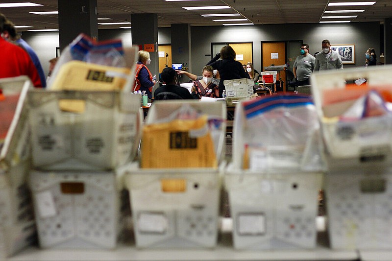 Election workers count absentee ballots into the early morning, Wednesday, Nov. 4, 2020 in Milwaukee at a central counting facility.