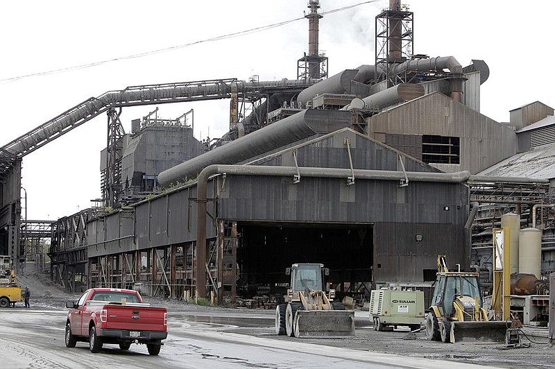 Vehicles are parked outside a facility at ArcelorMittal Steel mill in Cleveland in this file photo. With production in a slump and jobs near an all-time low, the U.S. steel industry is seeking a long-term solution.
(AP)