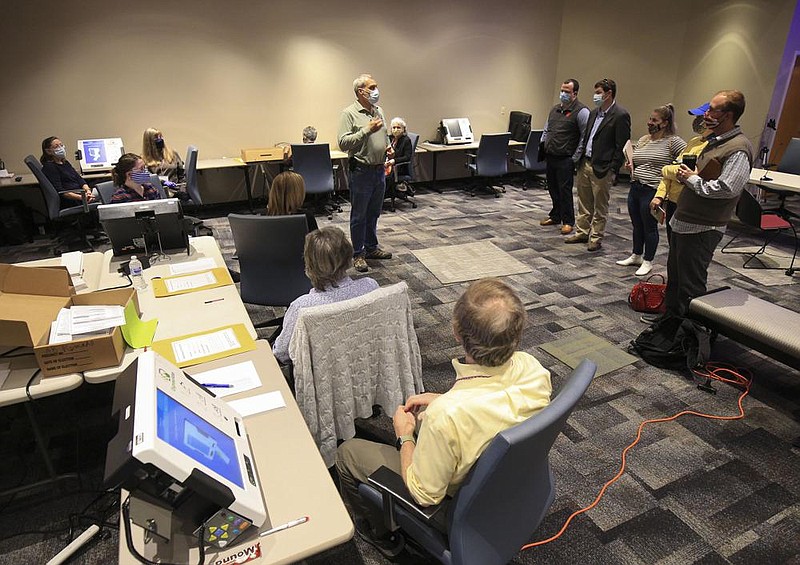 Shawn Camp (standing, left), assistant director of elections for the Pulaski County Election Commission, explains the ballot duplication process Thursday, Nov. 5, 2020, in Little Rock for poll watchers before election officials begin to create duplicate ballots to replace and tabulate defective and damaged ones from Tuesday’s election. More photos at arkansasonline.com/116ballots/.