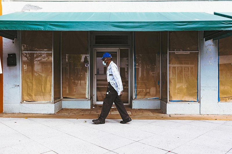 A man passes a closed business Thursday in West Palm Beach, Fla. The Labor Department reported Thursday that more than 750,000 workers filed new claims for state unemployment benefits last week, a slight decline from the previous week but still at a level that indicates many employers continue to cut jobs.
(The New York Times/Saul Martinez)