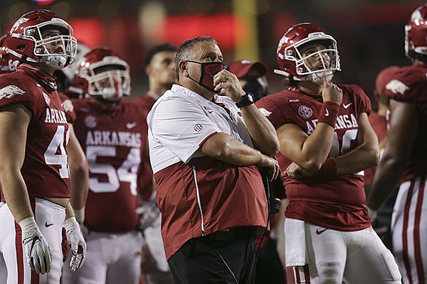 Arkansas football coach Sam Pittman (center) and players watch a replay during a game against Tennessee on Saturday, Nov. 7, 2020, in Fayetteville. 