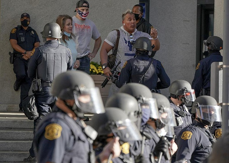 Police in riot gear line up between protest groups Friday outside the City County Building in Pittsburgh.
(AP/Gene J. Puskar)