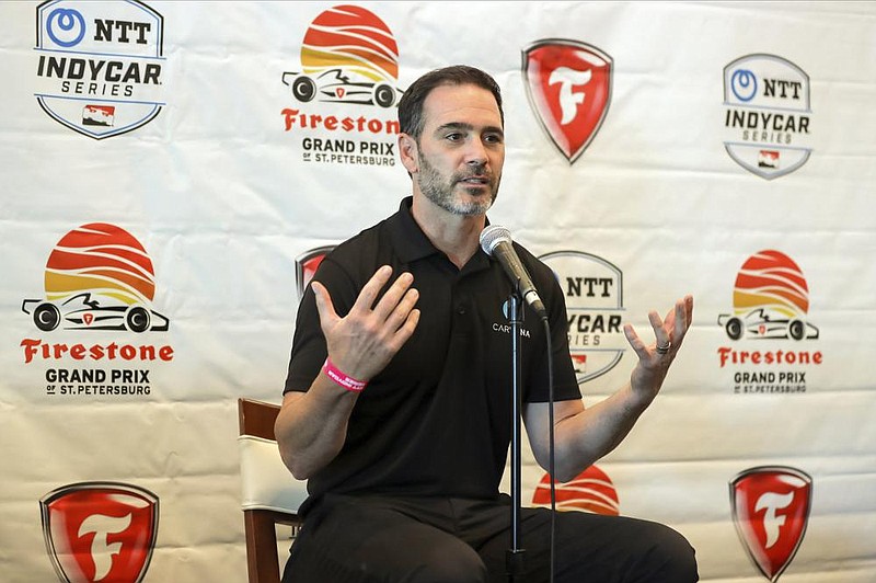 Jimmie Johnson speaks about joining the team of Chip Ganassi for the IndyCar series at a press conference during the IndyCar race weekend Saturday, Oct. 24, 2020, in St. Petersburg, Fla.   (AP Photo/Mike Carlson)