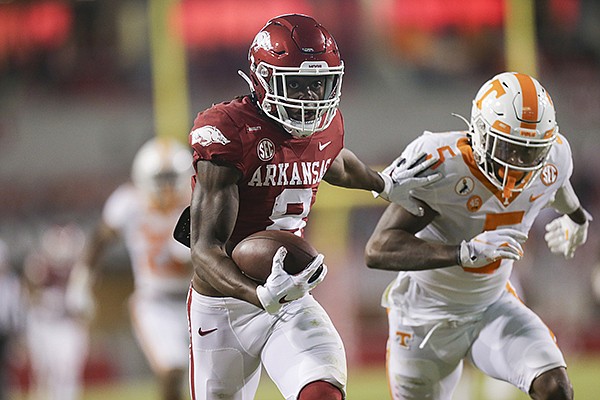 Arkansas receiver Mike Woods (8) is chased by Tennessee defensive back Kenneth George (5) near the end of a 56-yard reception during a game Saturday, Nov. 7, 2020, in Fayetteville. 