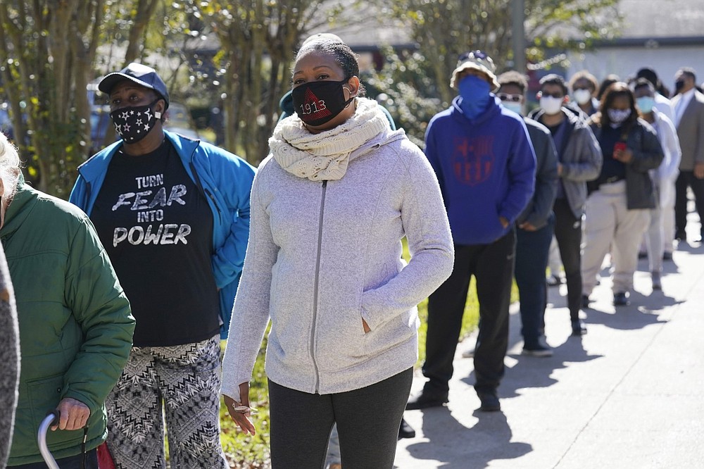 Voters stand in line at Precinct 36 as they wait to vote in the general election in Jackson, Miss., on Tuesday, Nov. 3, 2020. (AP Photo/Rogelio V. Solis)