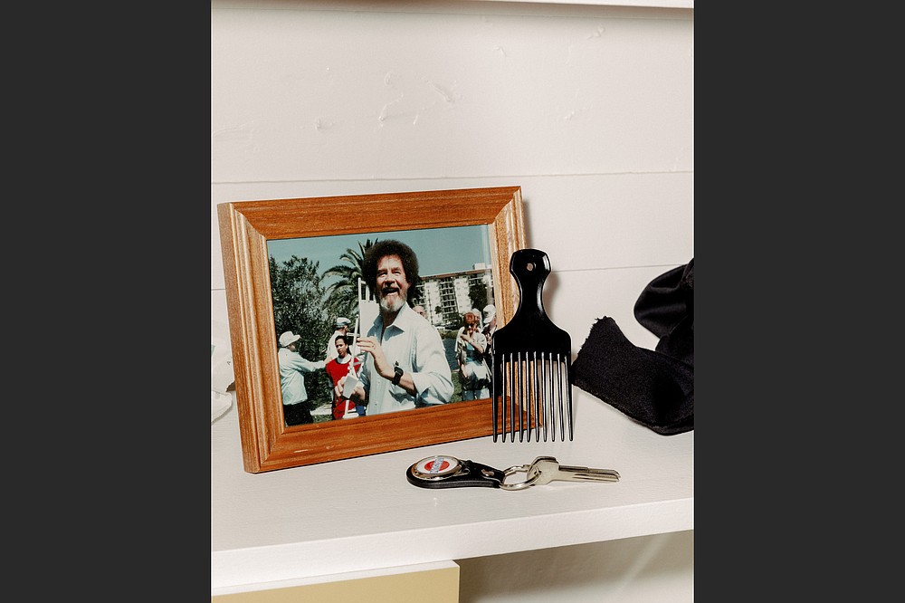 Bob Ross artifacts and memorabilia, including a hair pick, are displayed at the 