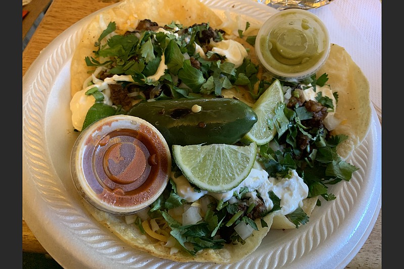 Three carne asada tacos cost $2 apiece at the Taco Mexicano food truck, parked on a Friday outside Simmons Bank Arena in North Little Rock. (Arkansas Democrat-Gazette/Eric E. Harrison)