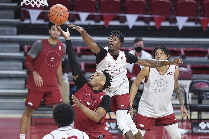Arkansas guard JD Notae (1) shoots as guard Davonte Davis (4) blocks,Thursday, November 11, 2020 during the Red-White instrasquad basketball game at Walton Arena in Fayetteville.