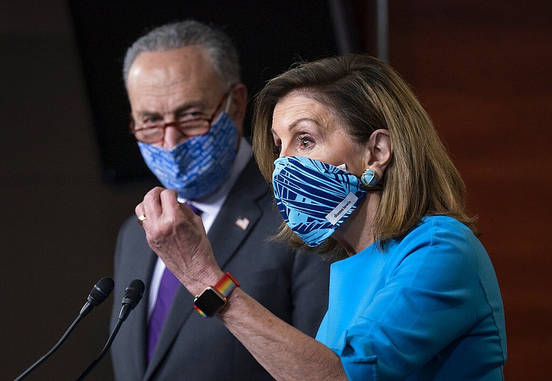 Speaker of the House Nancy Pelosi, D-Calif., and Senate Minority Leader Chuck Schumer, D-N.Y., left, meet with reporters on Capitol Hill in Washington, Thursday, Nov. 12, 2020.