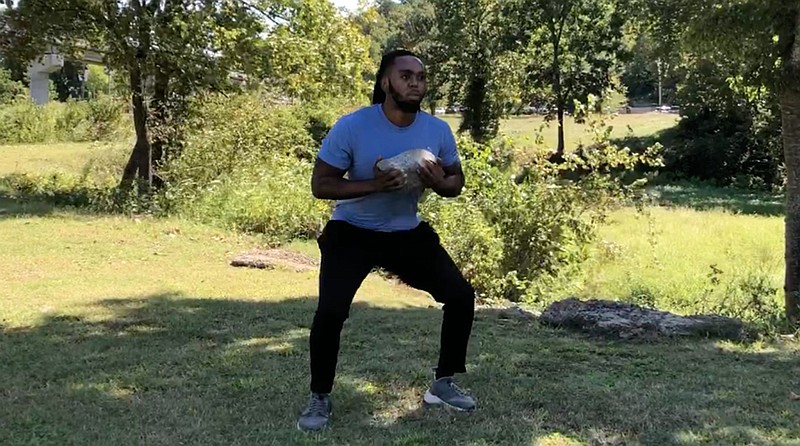 Emmanuel Eyiuche does the Rock Squat Half-Rep at River Mountain Park for Matt Parrott's Master Class. (Arkansas Democrat-Gazette/Celia Storey)