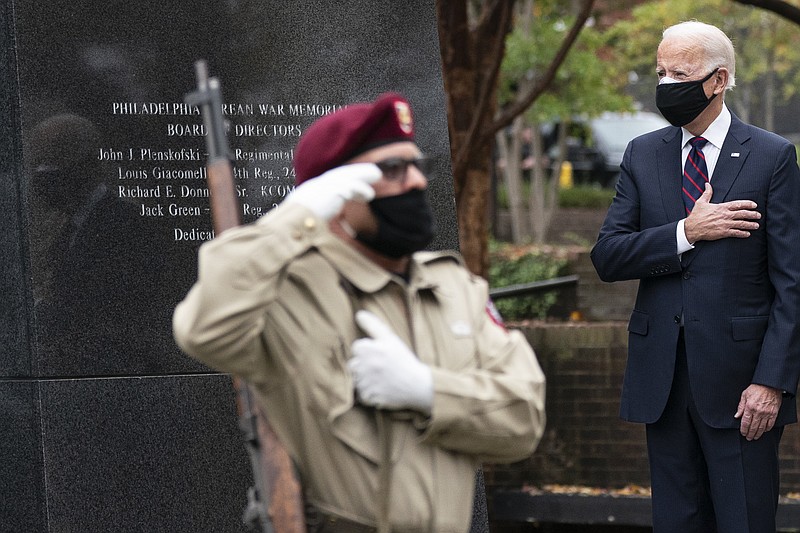 President-elect Joe Biden stands with his hand over his heart, after placing a wreath at the Philadelphia Korean War Memorial at Penn’s Landing, on Veterans Day, Wednesday, Nov. 11, 2020, in Philadelphia.