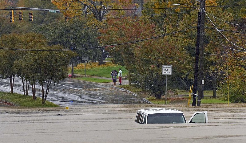 A vehicle is submerged in floodwaters Thursday in Charlotte, N.C., after Tropical Storm Eta worked its way north from Florida. More photos at arkansasonline.com/1113eta/.
(AP/The Charlotte Observer/Jeff Siner)