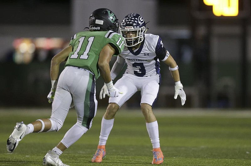 Greenwood’s Jayden Jasna (3) covers Van Buren’s Jaiden Henry during a game in Van Buren on Oct. 30. “He’s that lockdown guy for us that we can put on the single side,” defensive coordinator Jason Gill said. “He just allows us to do a lot of different things with the defense because we can trust him over there one-on-one with whoever their best guy is.”
(NWA Democrat-Gazette/Charlie Kaijo)