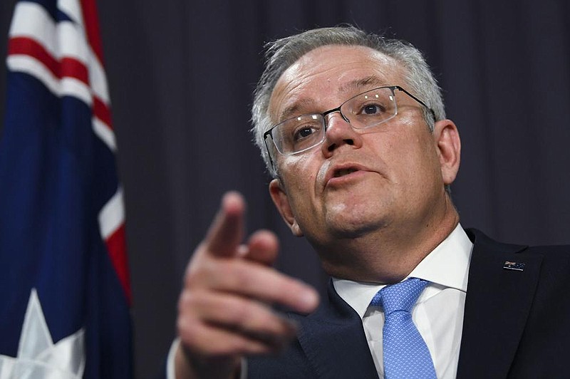 Australian Prime Minister Scott Morrison discusses his phone call Thursday with former Vice President Joe Biden during a news conference at Parliament House  in Canberra. Morrison said he invited Biden to visit next year to celebrate the 70th anniversary of the two countries’ shared defense treaty.
(AP/AAP Image/Lukas Coch)