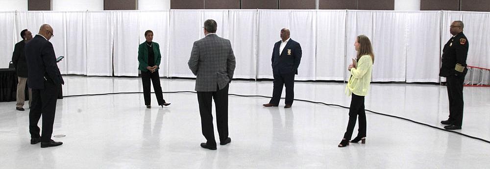 In the early days of the pandemic, city, county and hospital officials, maintaining a distance from one another, put together last minute details of a news conference to provide updates on the covid-19 pandemic in Jefferson County. The news conference — one of the first of a series of news conferences, meetings and other gatherings held in the Pine Bluff Convention Center banquet room — was limited to city officials and media, and it was live-streamed on the city’s Facebook page. Pictured are: Pine Bluff Mayor Shirley Washington (from left); Jefferson Regional Medical Center CEO Brian Thompson; Pine Bluff Police Chief Kelvin Sergeant; and Jefferson Regional Medical Center Chief Experience Officer Wendy Talbot. (Arkansas Democrat-Gazette file photo/Dale Ellis)