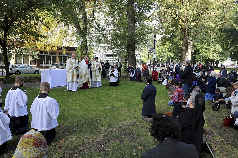 Archbishop Alexander Sample conducts an exorcism to rid the city of evil influences in the North Park Blocks of Portland, Ore., during a rosary and exorcism for peace and justice in the city. They performed the rite in well-attended outdoor ceremonies to drive out any evil spirits lingering after acrimonious protests.

(Catholic Sentinel via AP/Ed Langlois)