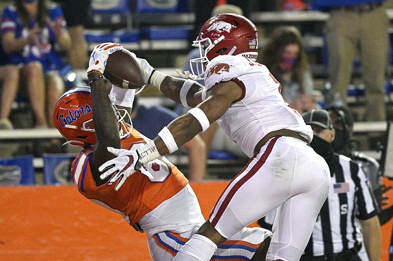 Florida wide receiver Justin Shorter (left) catches a pass in the end zone for a 21-yard touchdown in front of Arkansas defensive back Jalen Catalon during the first half of an NCAA college football game in Gainesville, Fla., on Saturday, Nov. 14, 2020.