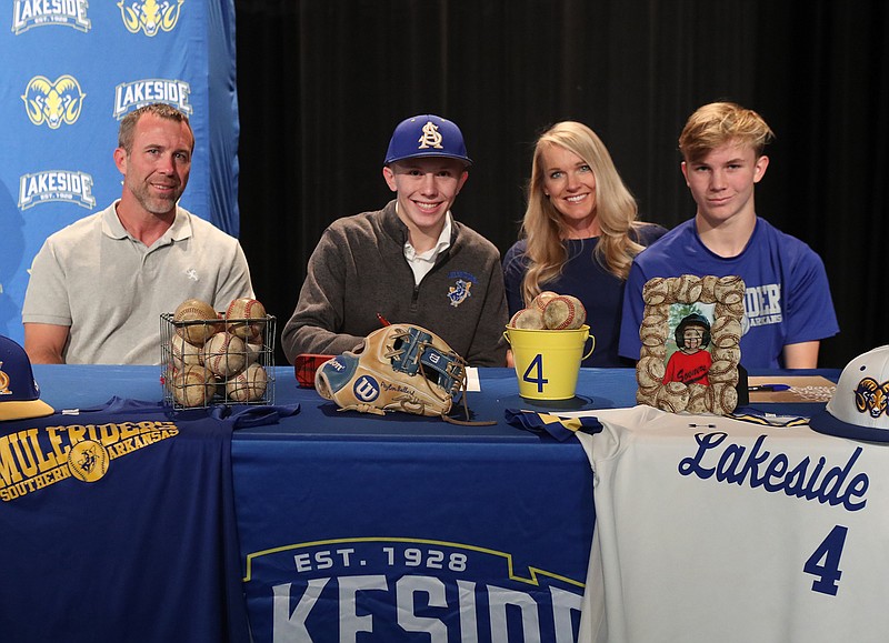 Peyton Ballard, second from left, with his father Luke, left, mother Mandy and brother Ryan Friday after signing a letter of intent to play baseball at Southern Arkansas University. - Photo by Richard Rasmussen of The Sentinel-Record