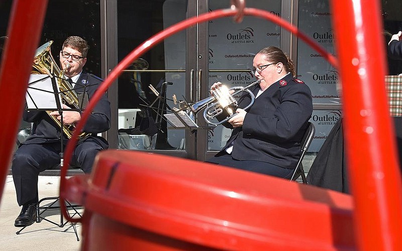 Bandmaster Andrew Barrington and Maj. Holly Needham, members of the Salvation Army Brass Band Ensemble, perform during the Red Kettle and Angel Tree Kick Off on Friday at the Outlets of Little Rock. See more photos at arkansasonline.com/1114kettle/.