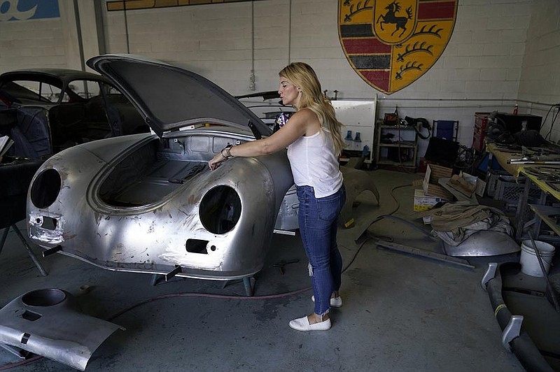 Laurina Esposito, co-owner of a Porsche-restoration shop in Los Angeles, said she had to rely on her employees to keep the company  running during her debilitating three-week bout with covid-19. 
(AP/Marcio Jose Sanchez)