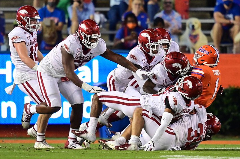 The Arkansas defense gang-tackles Florida’s Kadarius Toney during Saturday’s game. The Razorbacks
became the first team this season to stop the Gators from scoring after they had the ball inside the opponent’s 20.
(University of Arkansas/Walt Beazley)