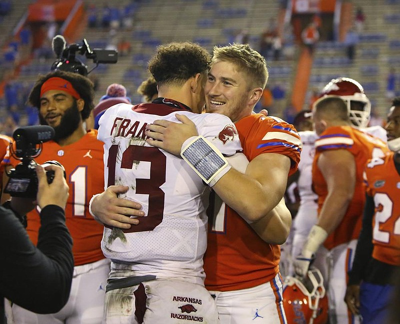 Arkansas quarterback Feleipe Franks (13) hugs his former team- mate, Florida quarterback Kyle Trask, after the Gators’ 63-35 victory over the Razorbacks on Saturday night. Arkansas hosts LSU on Saturday. 
(AP/The Gainesville Sun/Brad McClenny) 