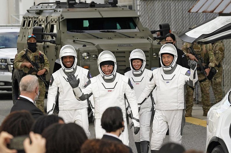 Astronauts, from left, Victor Glover, Michael Hopkins, Shannon Walker, and Japan Aerospace Exploration Agency astronaut Soichi Noguchi wave to family and friends as they leave the Operations and Checkout Building for a trip to Launch Pad 39-A and a planned liftoff on a SpaceX Falcon 9 rocket with the Crew Dragon capsule on a six-month mission to the International Space Station Sunday, Nov. 15, 2020, at the Kennedy Space Center in Cape Canaveral, Fla. (AP Photo/John Raoux)