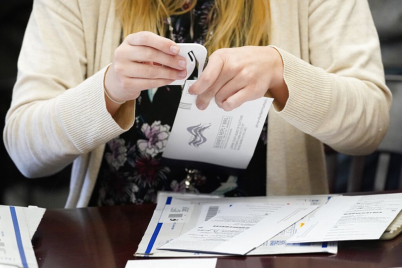 A Luzerne County worker canvases ballots that arrived after closing of voting until Friday at 5 p.m. and postmarked by Nov. 3rd as vote counting in the general election continues, Friday, Nov. 6, 2020, in Wilkes-Barre, Pa. (AP Photo/Mary Altaffer) story.lead_photo.caption
