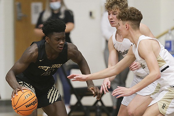 Little Rock Central's Annor Boateng (left) drives against a pair of Bentonville defenders during a game Saturday, Nov. 14, 2020, in Bentonville. 