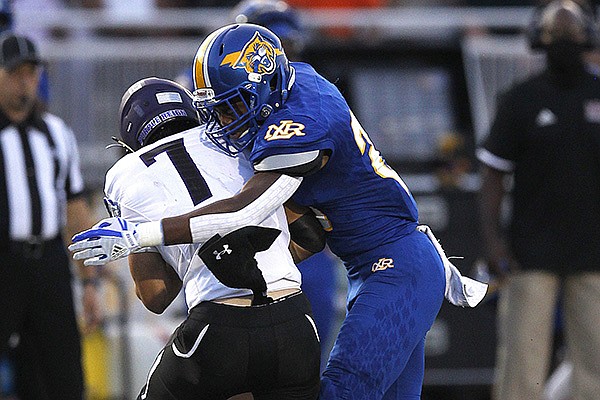 North Little Rock linebacker Davian Vayson (28) sacks Fayetteville quarterback Owen McCone (7) during the second quarter of North Little Rock's win on Friday, Sept. 11, 2020, at North Little Rock High School.
