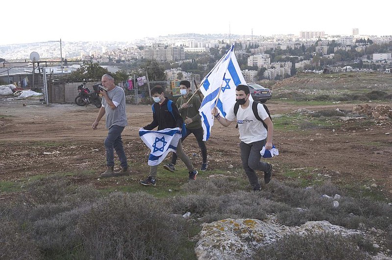 Protesters arrive at Monday’s news conference at the Givat Ha- matos settlement in east Jerusalem. (AP/Maya Alleruzzo) 