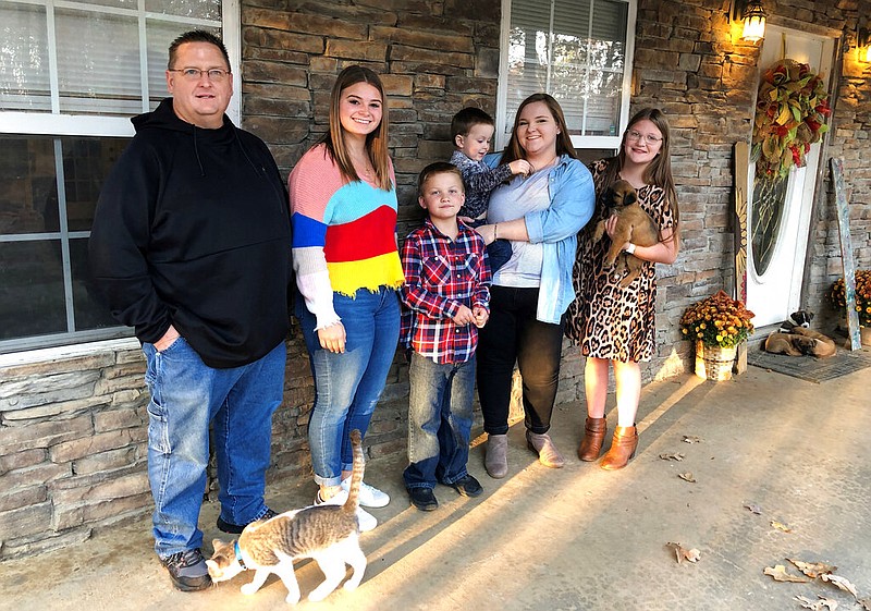 Keith Michael, left, poses with his children, from left, Jessica, Hunter, Houston, Sara and Holly, outside their home on Friday, Nov. 13, 2020, in Jonesboro.