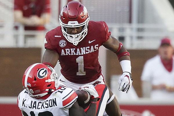Arkansas safety Jalen Catalon (1) tackles Georgia receiver Kearis Jackson during a game Saturday, Sept. 26, 2020, in Fayetteville.