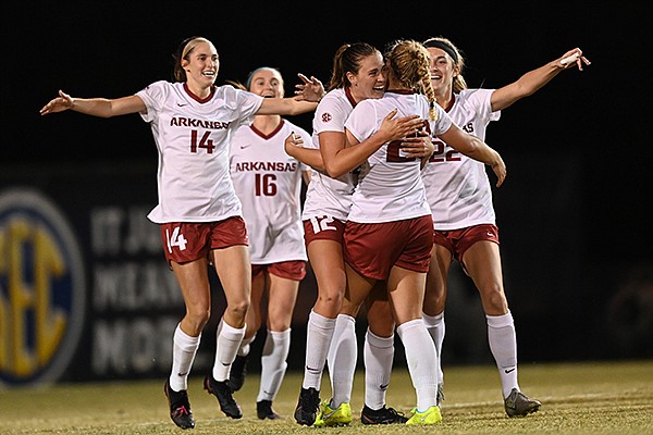 Arkansas players celebrate with freshman Emilee Hauser (facing opposite) after Hauser scored a goal during an SEC Tournament game against South Carolina on Thursday, Nov. 19, 2020, in Orange Beach, Ala.