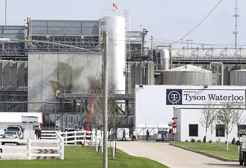 FILE - In this May 2020 file photo, Tyson's Fresh Meat workers file in for a tour of safety measures put into place after the plant in Waterloo, Iowa, had to shut down due to a covid-19 outbreak.