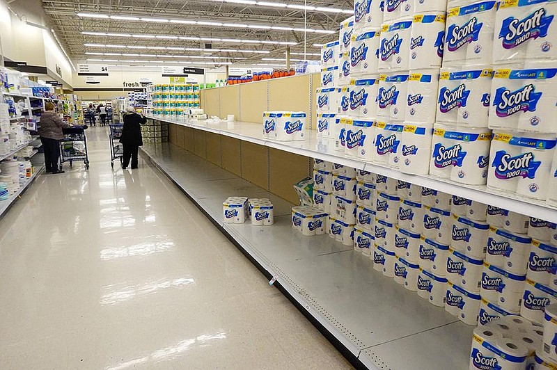 Shelves in the paper towel and toilet tissue aisle are depleted Tuesday at a Meijer Store in Carmel, Ind. A surge in coronavirus cases in the U.S. is prompting people to stockpile items again, forcing retailers to put limits on some purchases.
(AP/Michael Conroy)