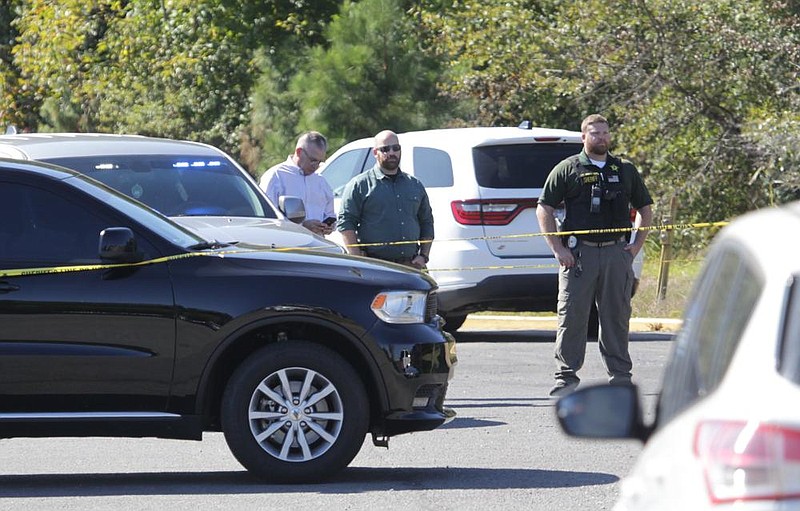 Investigators stand in the parking lot of the Econo Lodge motel at 210 N. Blake St. in Pine Bluff after the Oct. 5 shooting that claimed the life of police detective Kevin Collins and left Lt. Ralph Isaac wounded. Both officers, along with officer Kelsey Collins, were working on an investigation when they were involved in a shootout in the motel parking lot.
(Pine Bluff Commercial/Dale Ellis)