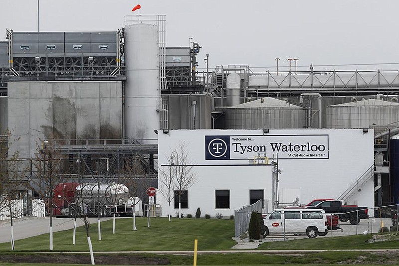 Vehicles sit outside the Tyson Foods plant in Waterloo, Iowa, in May. A recently amended wrongful-death lawsuit claims that the plant’s manager “organized” a betting pool for supervisors and managers to guess how many employees would test positive for covid-19.
(AP)