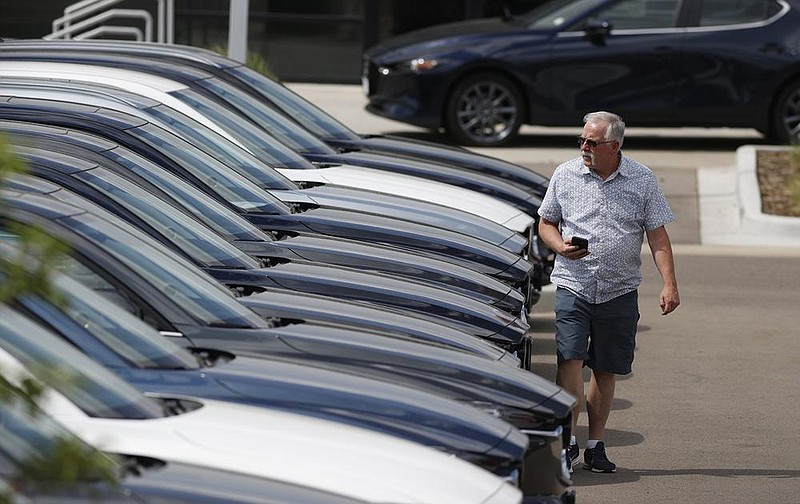 A prospective buyer looks over a row of 2020 CX-5 sports utility vehicles at a Mazda dealership in Littleton, Colo., in June. Mazda Motor Corp. vehicles led Consumer Reports’ latest auto-reliability survey.
(AP)