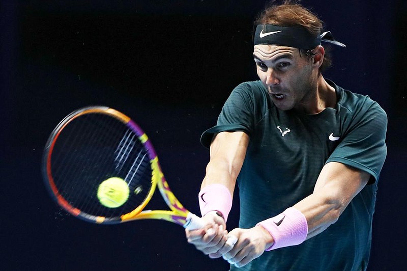 Rafael Nadal of Spain hits a forehand Thursday during a 6-4, 4-6, 6-2 victory over Stefanos Tsitsipas of Greece at the ATP World Tour Finals in London.
(AP/Frank Augstein)