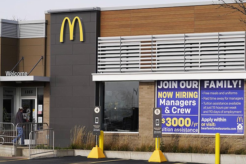 A hiring sign sits Thursday outside of McDonald’s in Buffalo Grove, Ill. The number of applications for unemployment benefits nationally rose sharply last week.
(AP/Nam Y. Huh)
