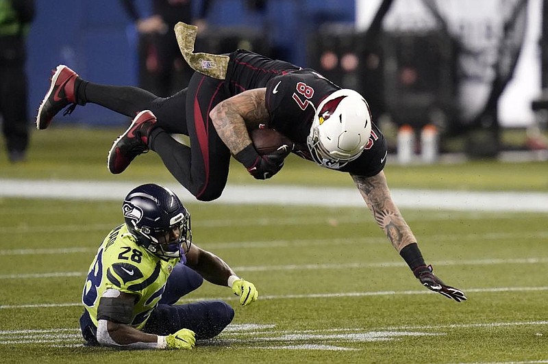 Arizona Cardinals tight end Maxx Williams (87) is upended by Seattle Seahawks safety Ugo Amadi during the second half Thursday in Seattle. The Seahawks won 28-21. More photos at arkansasonline.com/1120seattle/
(AP/Elaine Thompson) story.lead_photo.caption